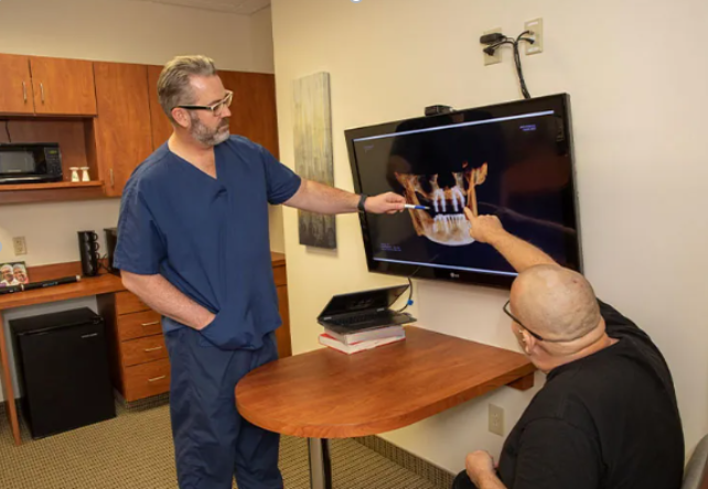 Dr. Leslee C. Timm working with a patient on the process of dental implants.